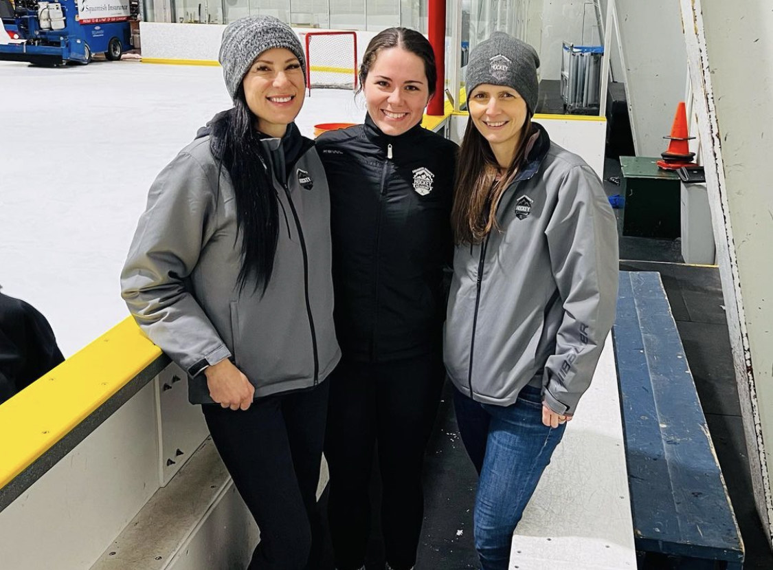 Evelyn Schellenberg and two other women standing together at the ice rink